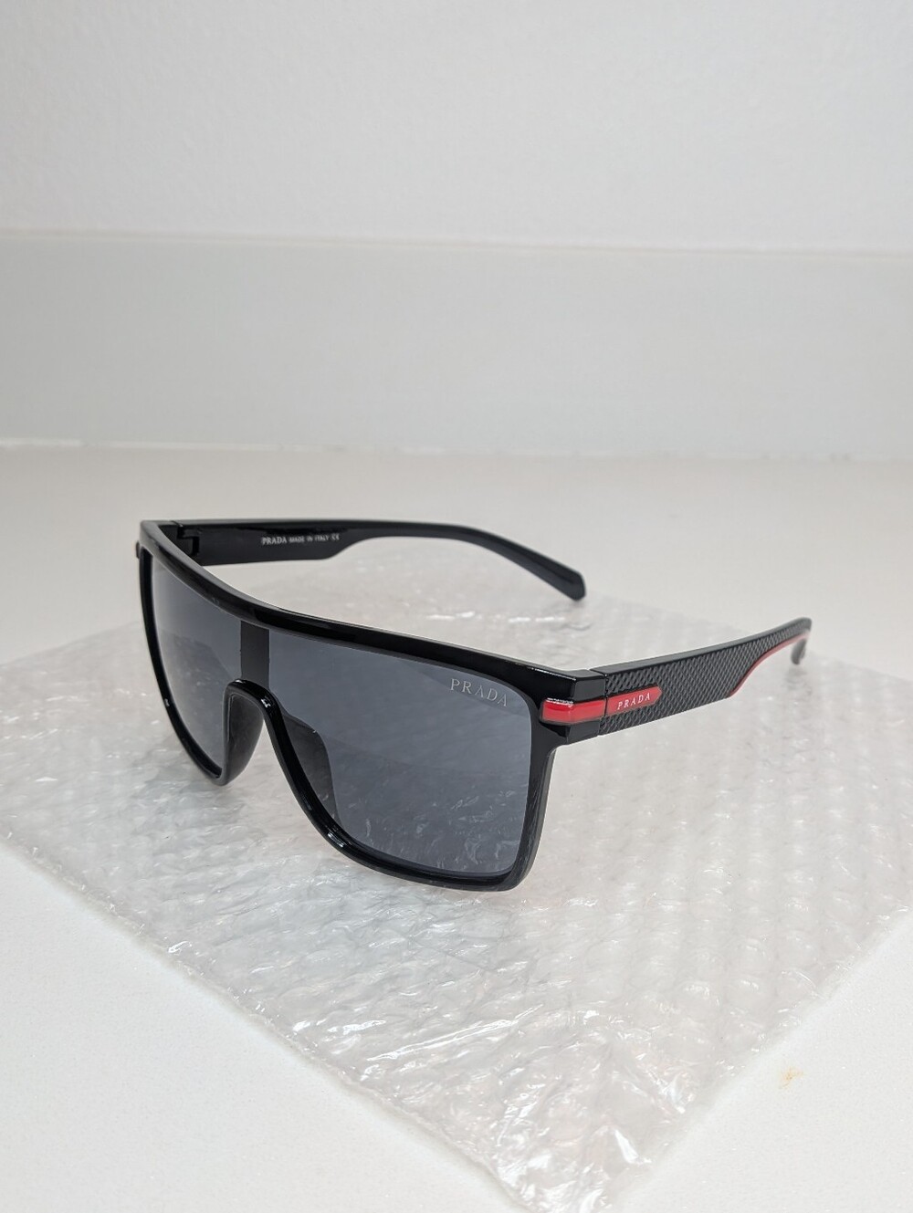 Prada Men’s Black Shield Sunglasses Red Logo Sport